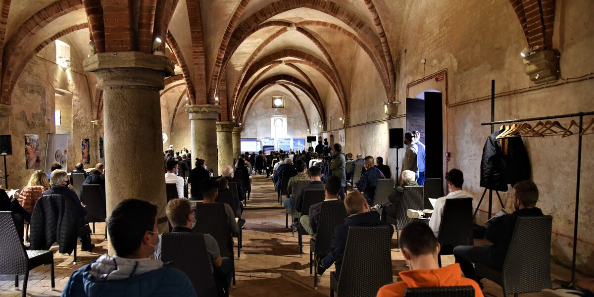 Foresteria dell'Abbazia di Staffarda: foto interna con la sala colonnata piena di pubblico, circa un centinaio di persone.