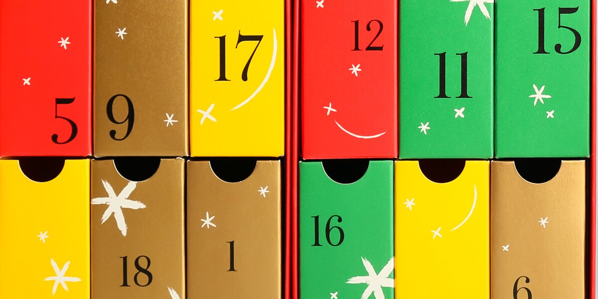 alcuni contenitori di cartone colorati di rosso, giallo, verde e oro, con dei numeri sopra, a simboleggiare le date dell'avvento.